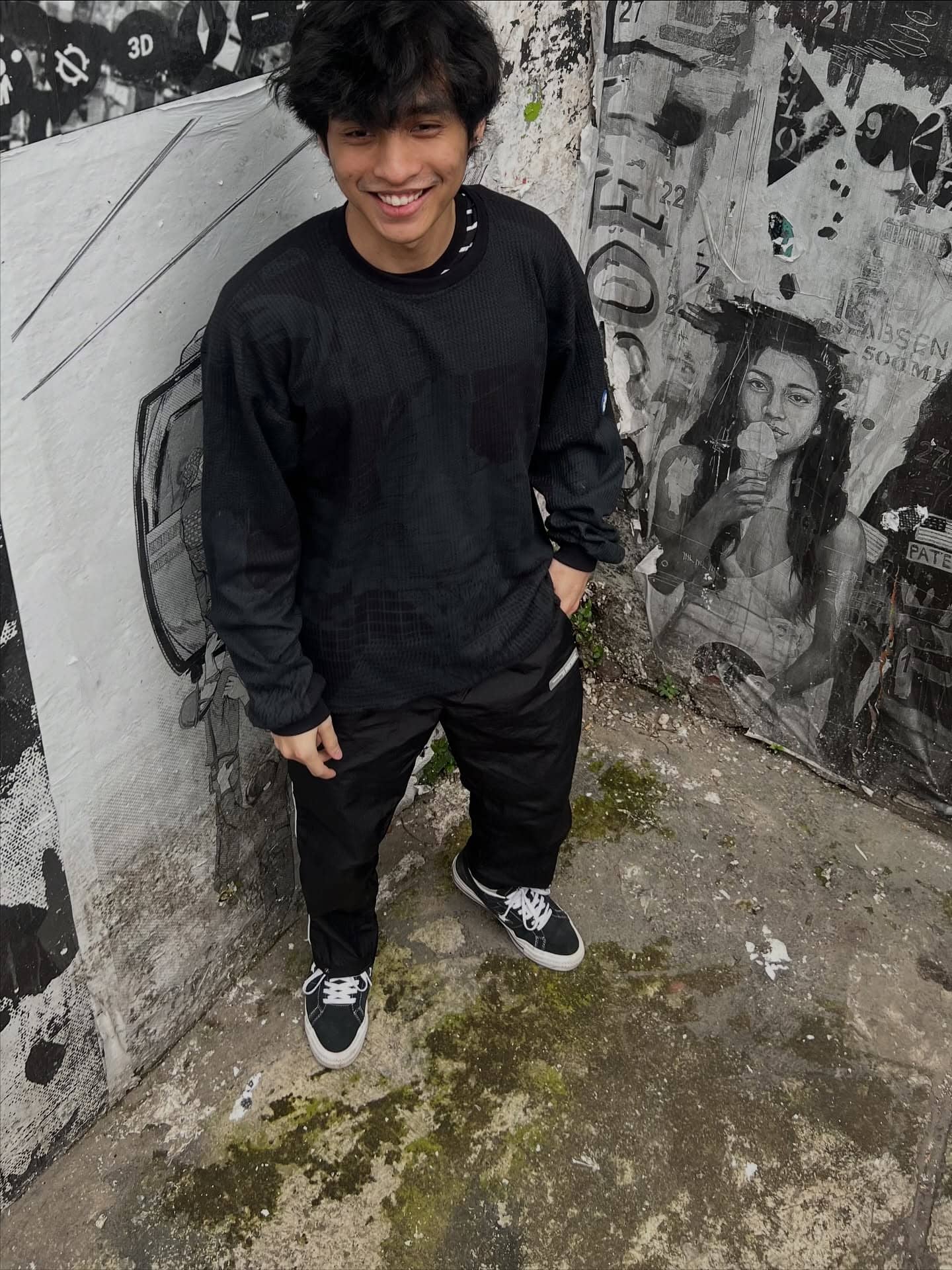 verrel leaning against a graffiti wall in jakarta